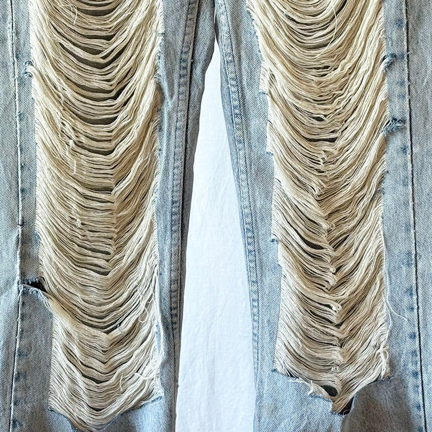 Distressed denim jeans with frayed edges on a white background