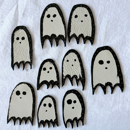Set of ghost-shaped leather patches on a white background