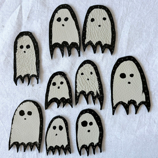 Set of ghost-shaped leather patches on a white background
