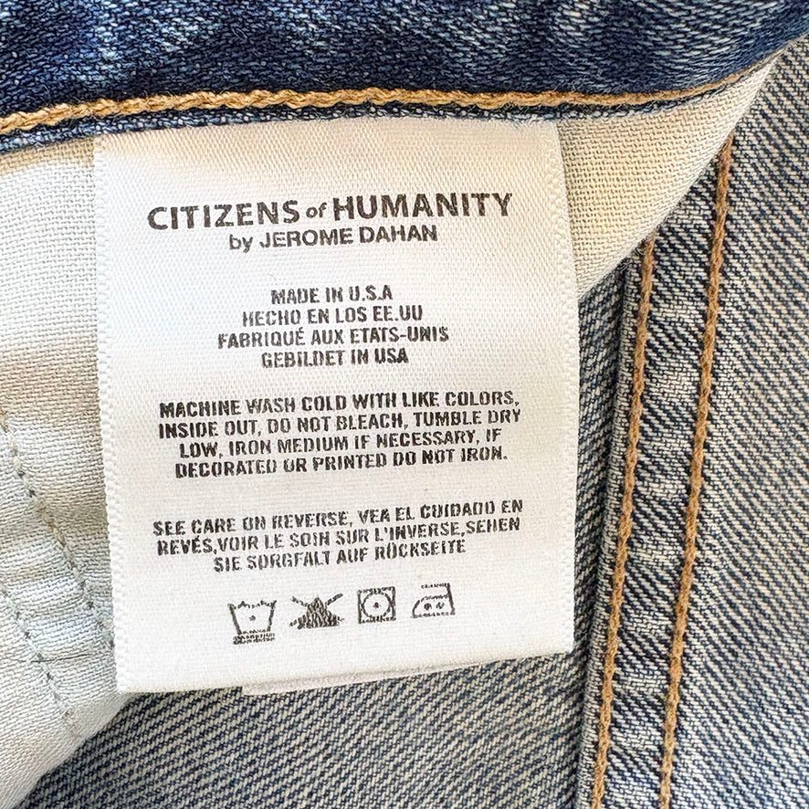 Label on denim fabric with 'Citizens of Humanity' branding and care instructions.