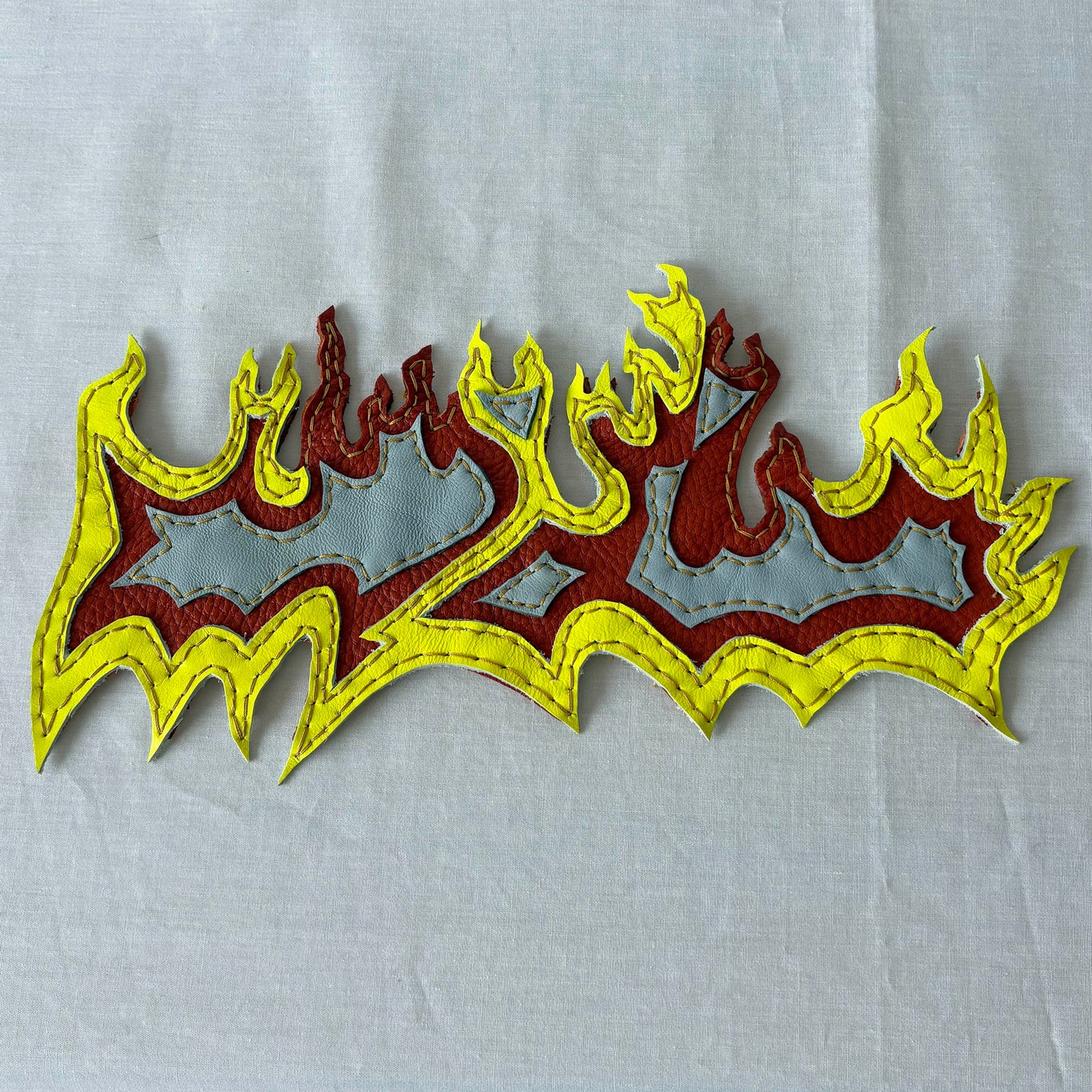 Layered leather flame patch.
