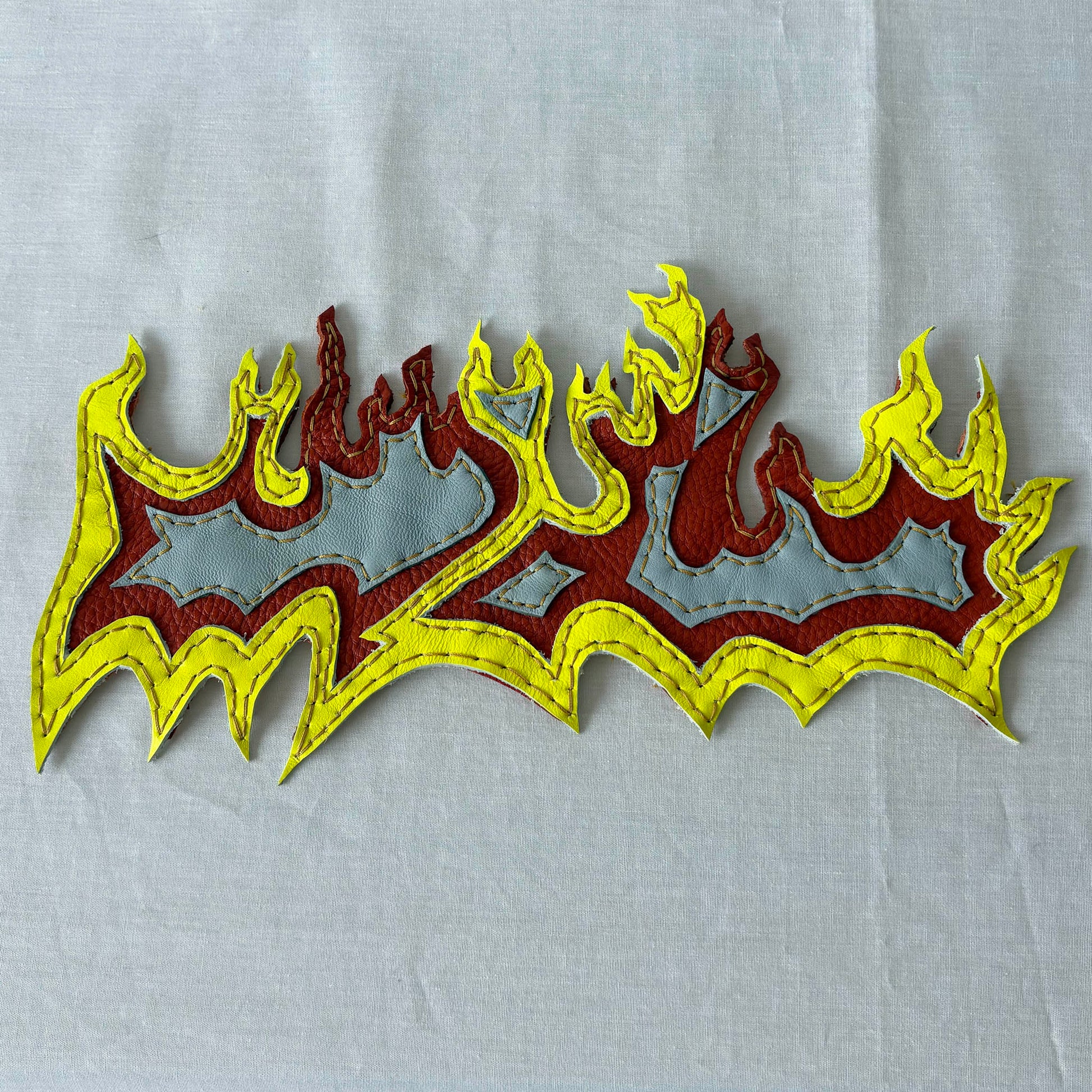 Layered leather flame patch.