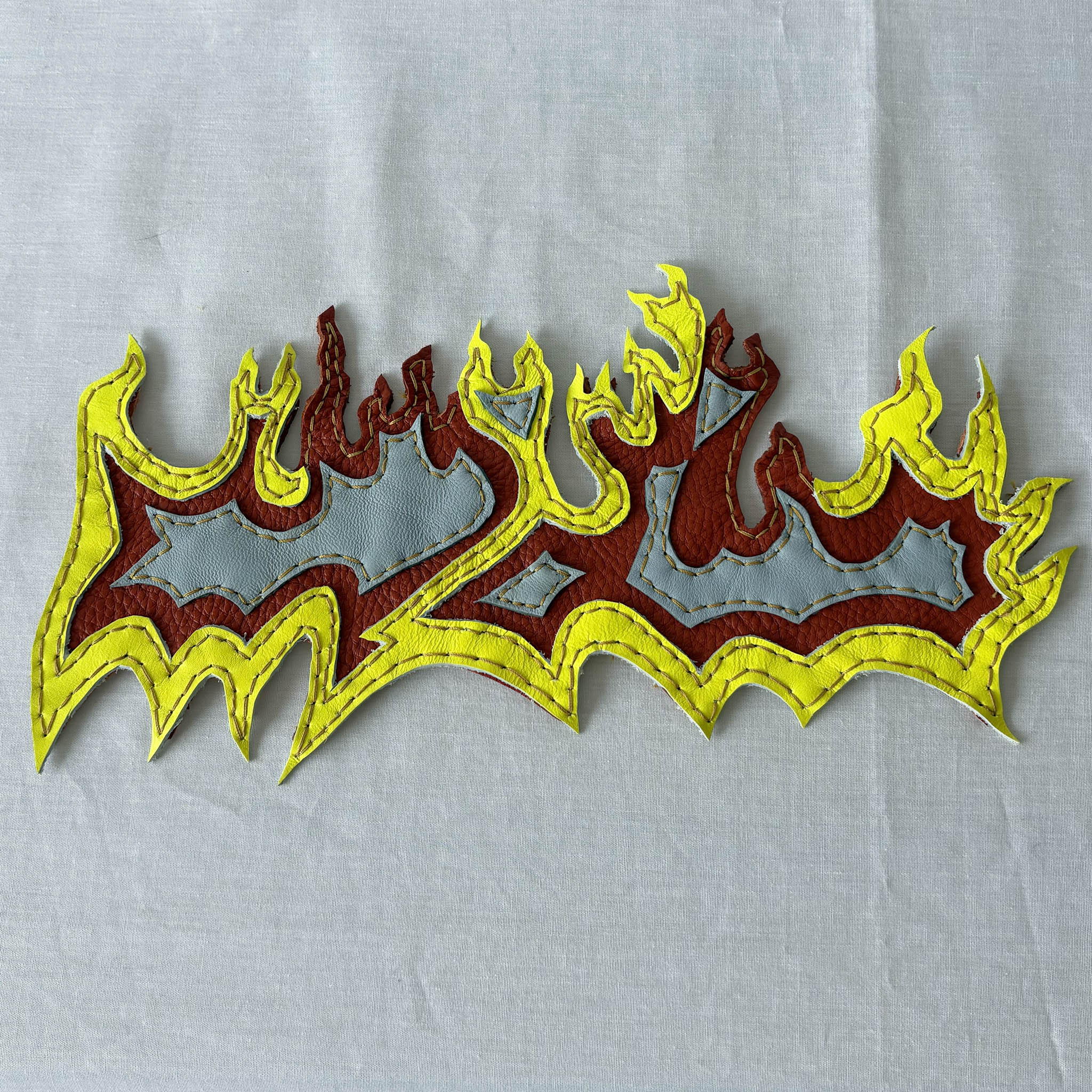 Layered leather flame patch.