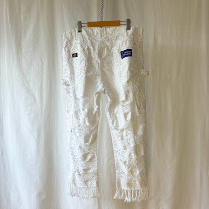 white pants with window pane distressing and completely stoned with 4 sizes of flat white rhinestones. 