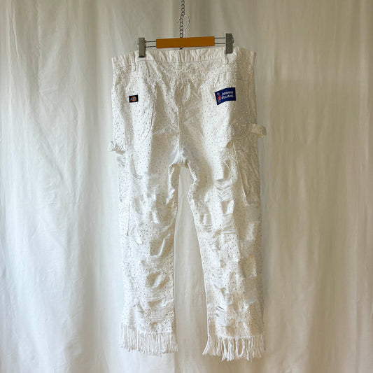 white pants with window pane distressing and completely stoned with 4 sizes of flat white rhinestones. 