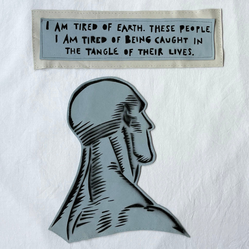 Dr. Manhattan leather and spray paint patch with quote patch "i am tired of earh. these people. i am tired of being caught in the tangle of their lives.