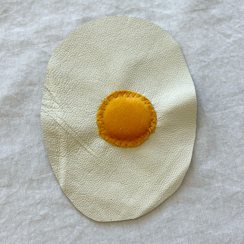 Leather and velvet fried egg patch.
