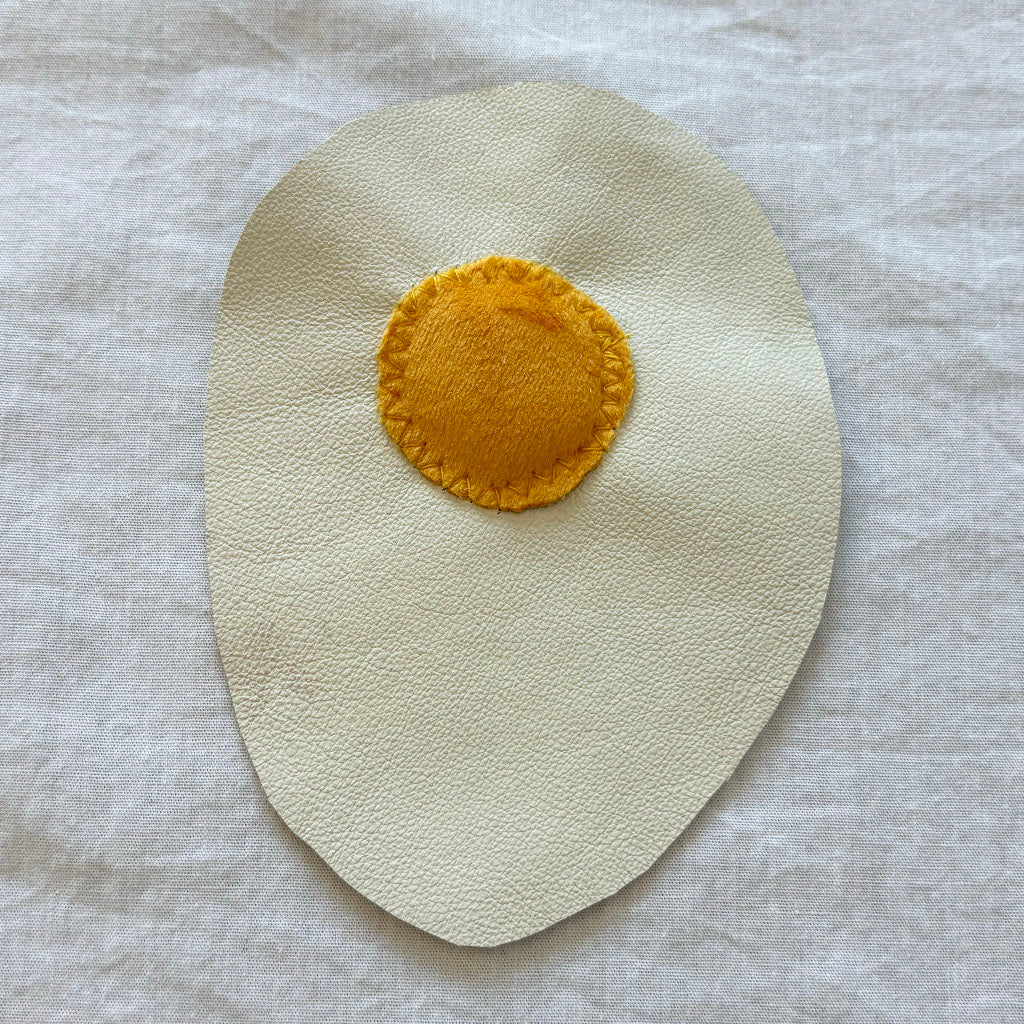 Leather and velvet fried egg patch.