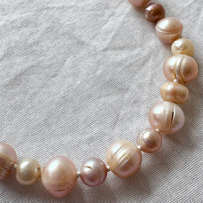 Pearl necklace on a textured fabric background