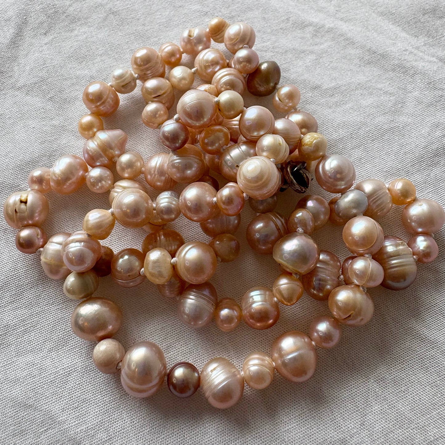 Pearl necklace on a light fabric background