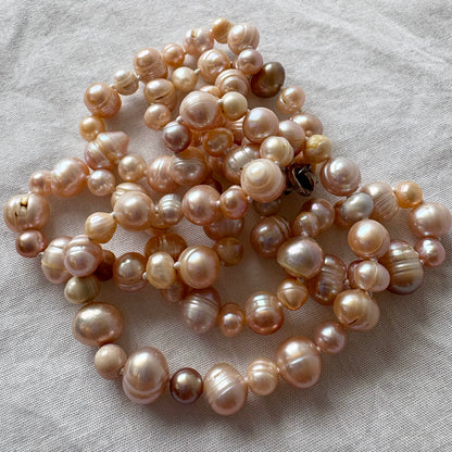 Pearl necklace on a light fabric background