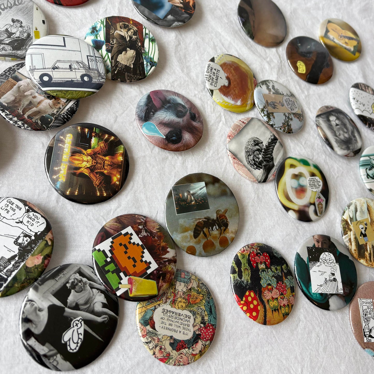 Collection of various round decorative items with different designs on a textured surface