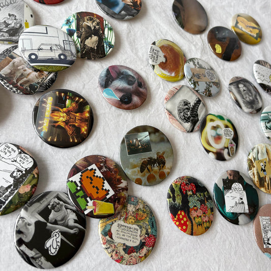 Collection of various round decorative items with different designs on a textured surface