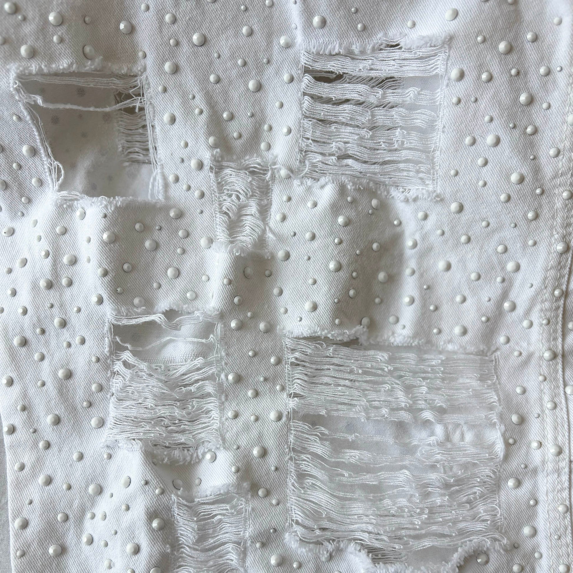White denim with flat white rhinestones in four sizes and distressed square holes