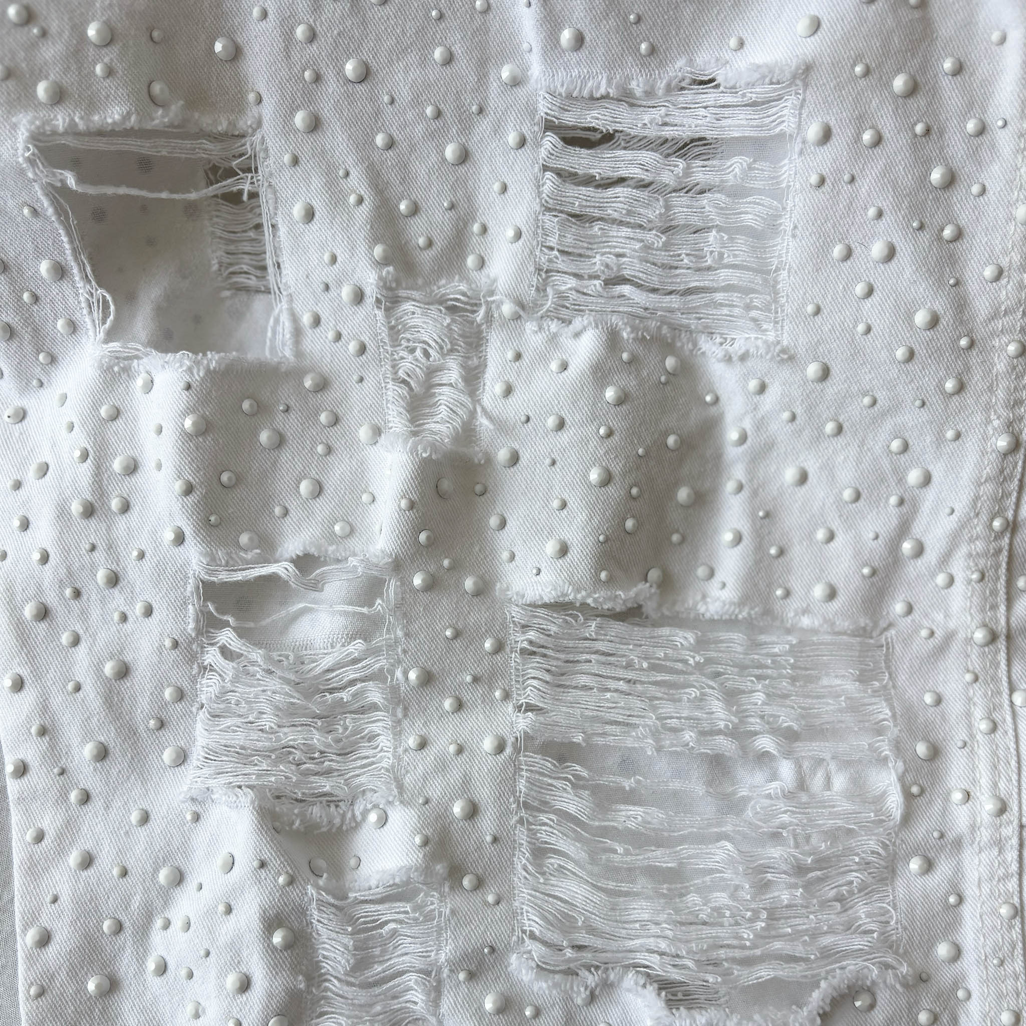 White denim with flat white rhinestones in four sizes and distressed square holes